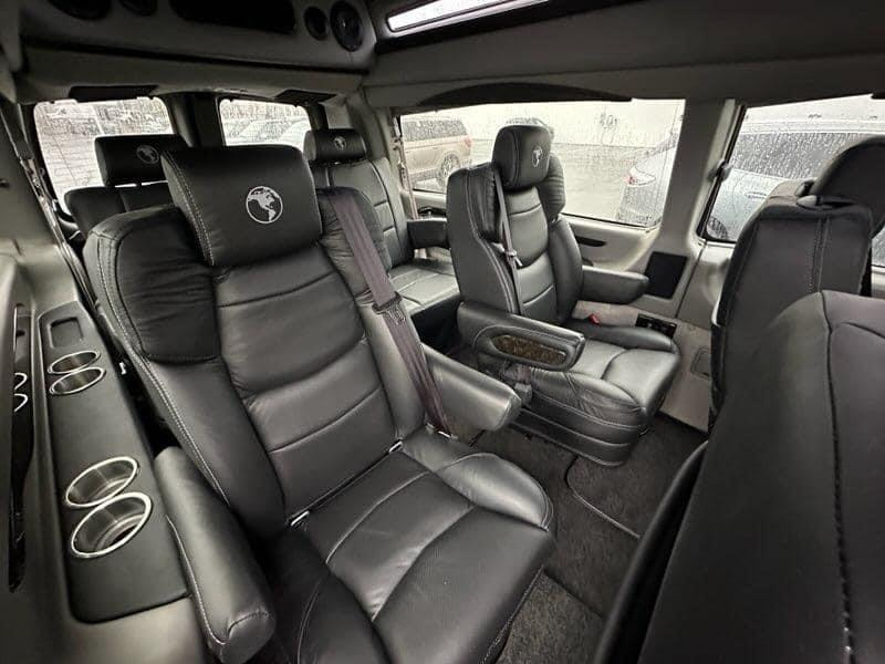 A car with black leather seats and grey carpet.